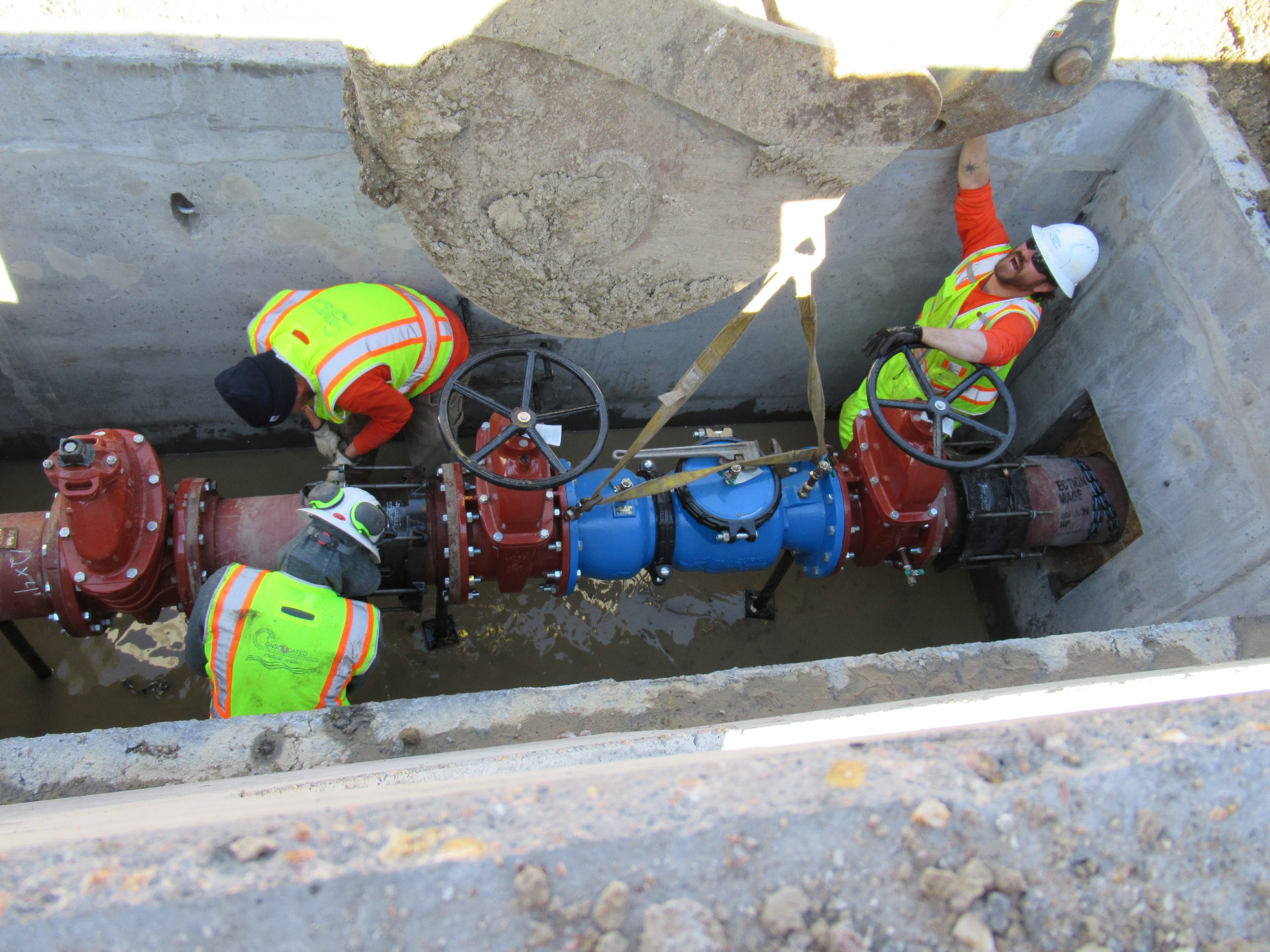 Employees replacing a pipe